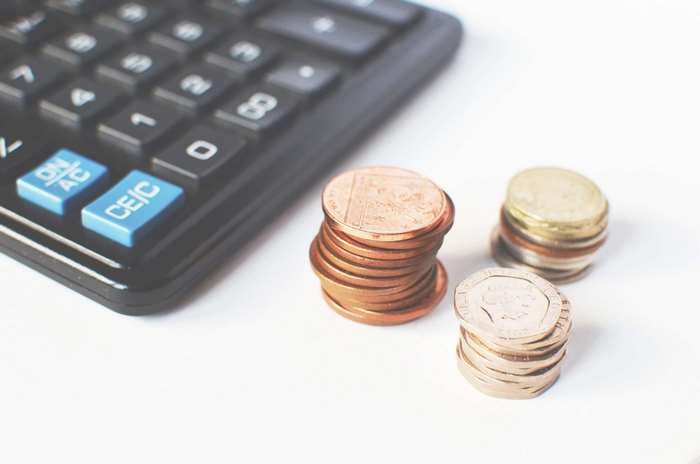 Calculator and stacks of coins