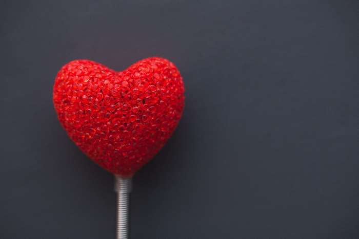 Red heart decoration on a dark background