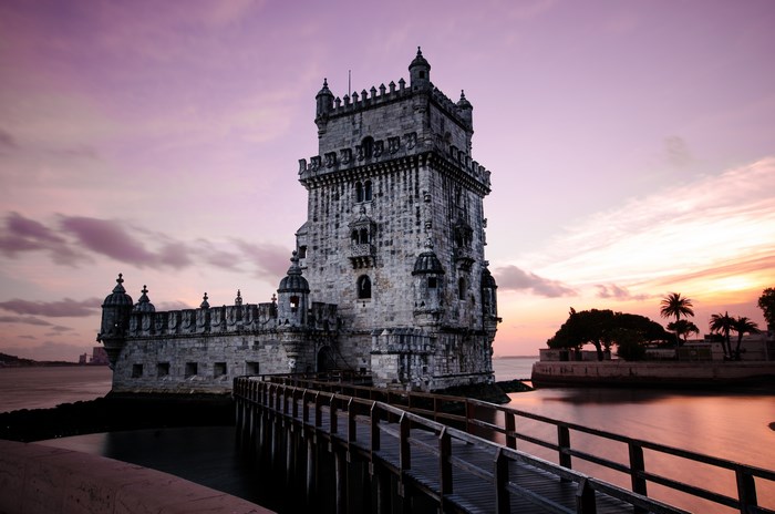 Historic Tower of Belem at Dawn with Bridge