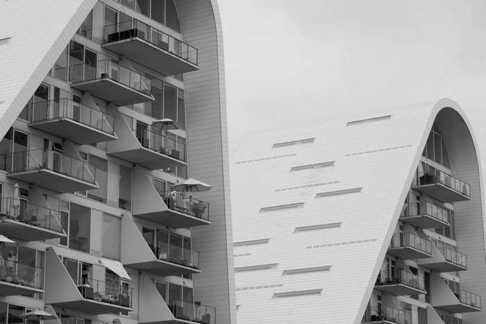 Modern architectural buildings with balconies and curved roofs