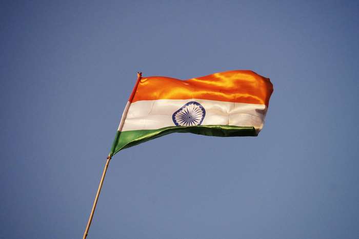 Indian flag waving against a blue sky