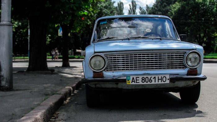 Blue vintage car parked on a street