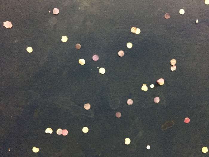 Confetti scattered on a dark surface