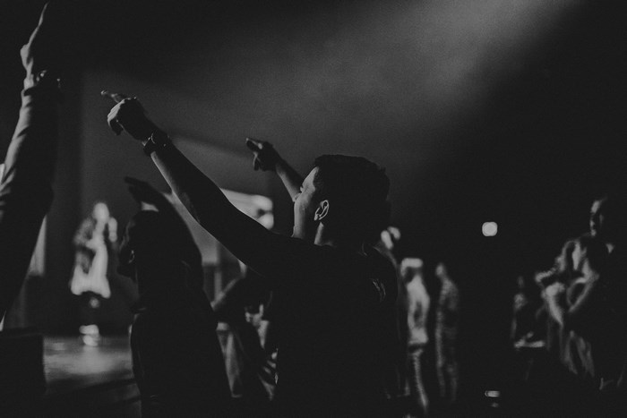 Crowd with hands raised at a performance