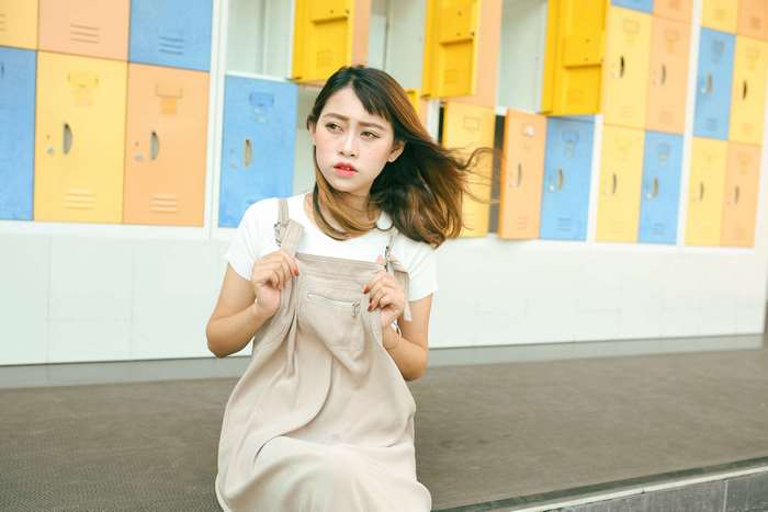 Woman in Overalls Posing in Front of Lockers 4K