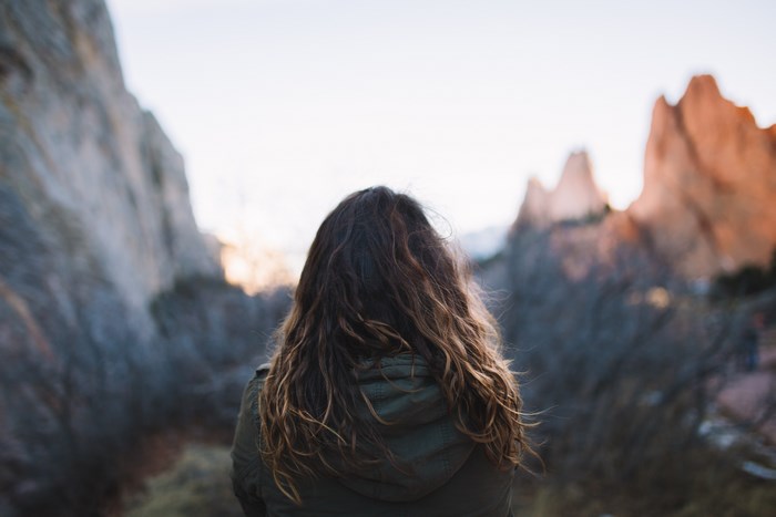 Woman with brown hair looking at mountains