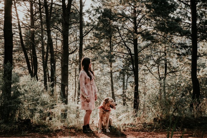 Woman and Golden Retriever in a Forest