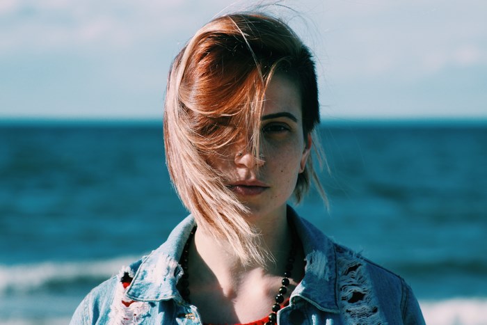 Woman with hair blowing in the wind at the beach
