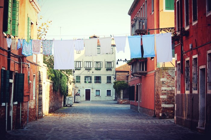 Venice street with laundry hanging across cobblestone alley