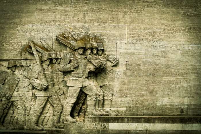 Soldiers marching in a stone relief sculpture