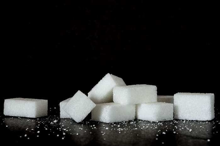 Pile of sugar cubes on a black background