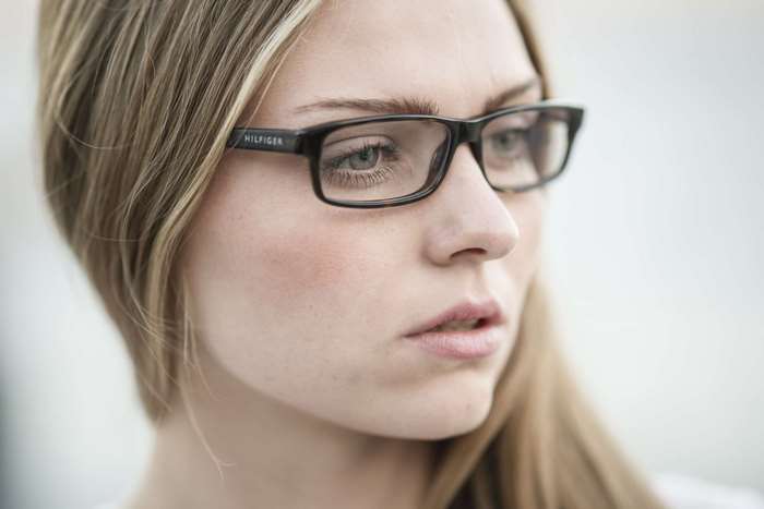 Woman wearing Tommy Hilfiger glasses, close up portrait