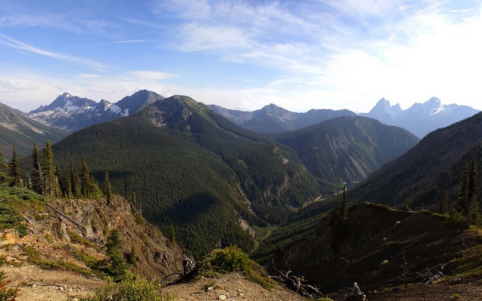 Panoramic view of forested mountains under a cloudy sky