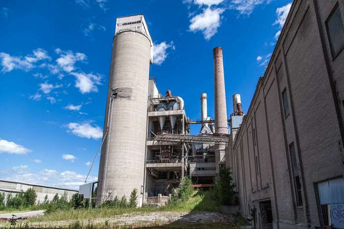 Abandoned industrial factory with silos and smokestacks