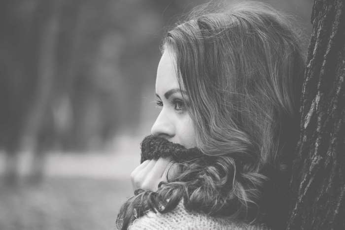 Black and white portrait of a young woman in a scarf
