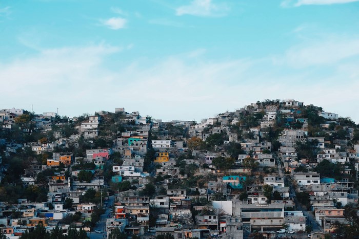 Monterrey hillside with colorful houses under blue sky