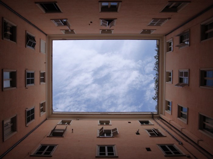 Looking up at a courtyard building in Rome, Italy