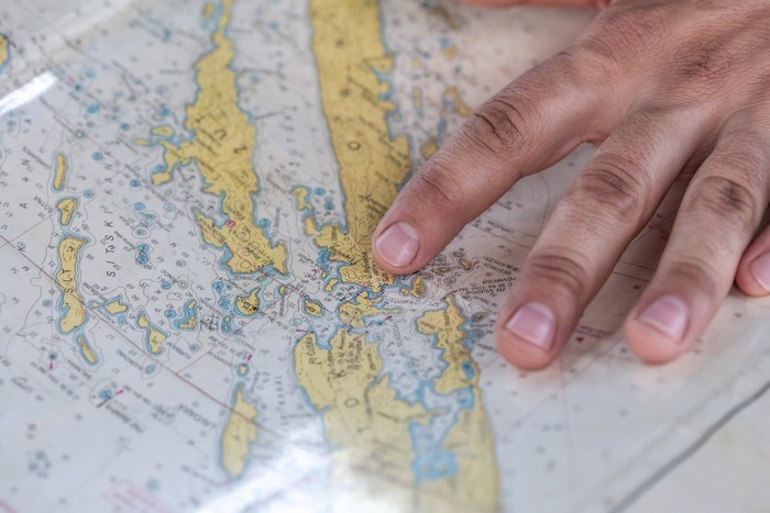 Hand pointing at a nautical map of Croatia