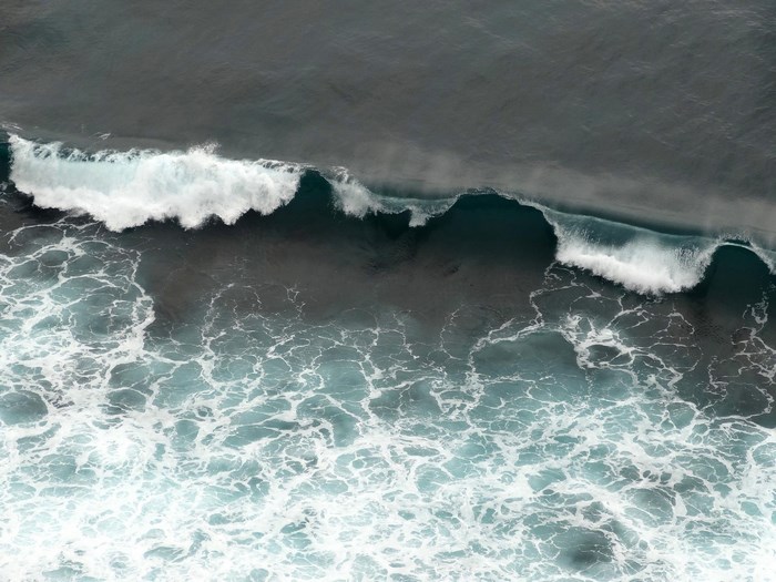 Aerial view of ocean waves crashing