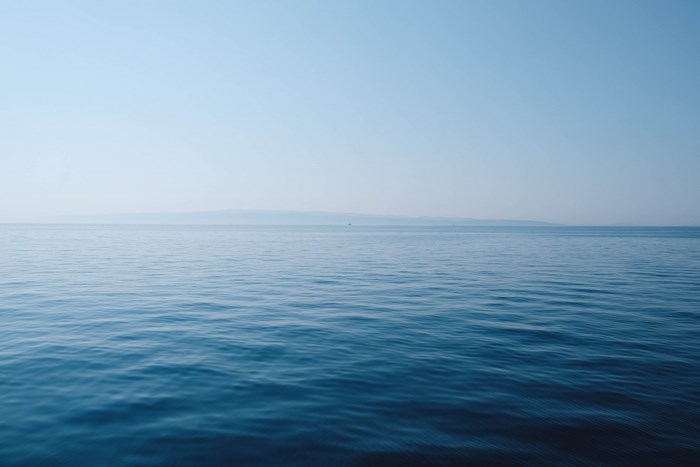 Vast blue ocean under a clear sky
