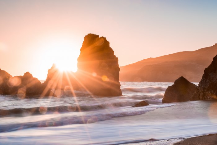 Sunset over the ocean with rock formations at Marin County