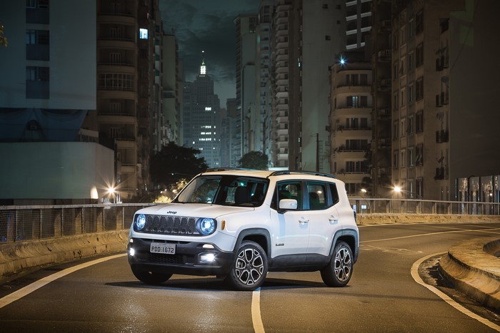 White Jeep Renegade Longitude parked on a city street at night