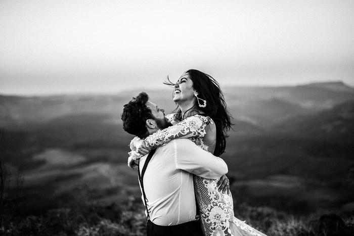 Couple embracing on a hill in black and white