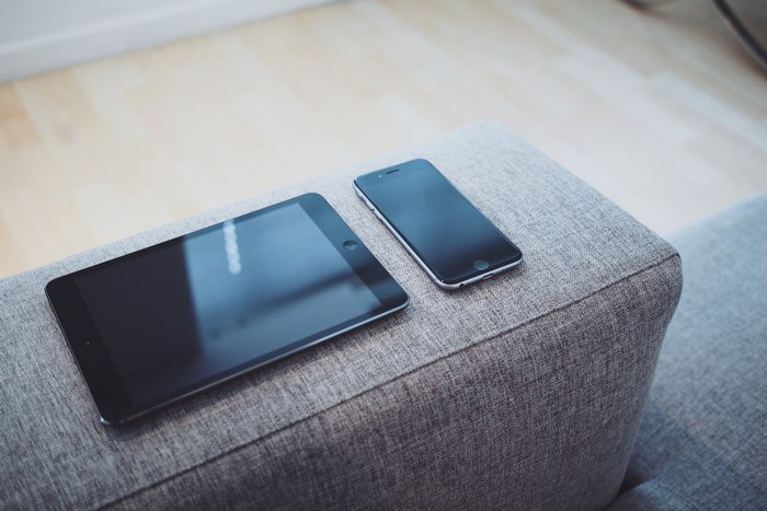 Apple iPad and iPhone on a Sofa