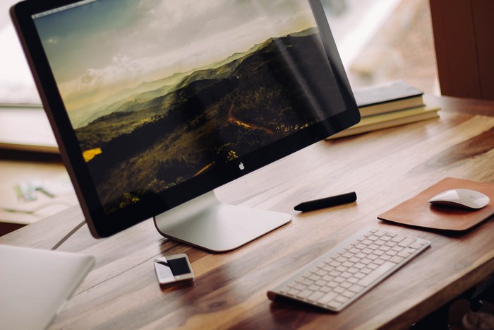 Modern workspace with Apple desktop and accessories