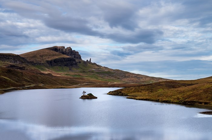 Lake with island and Old Man of Storr, Isle of Skye, Scotland