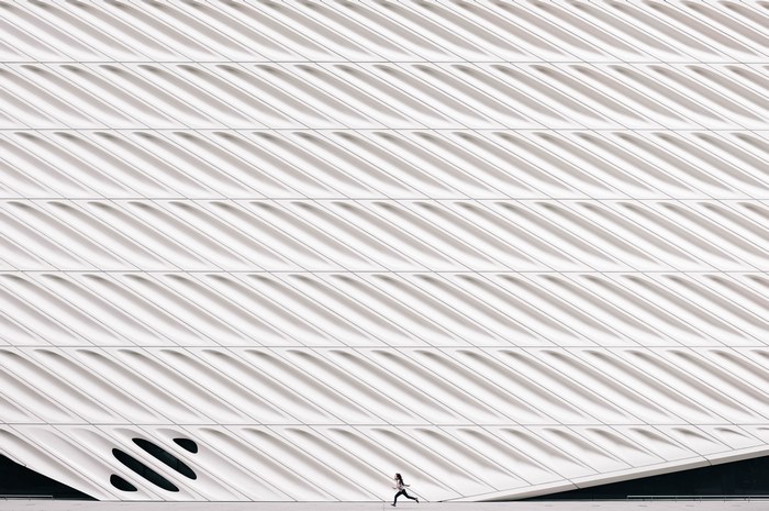 Girl running in front of The Broad museum facade