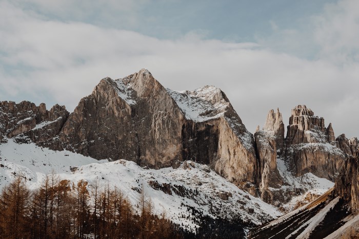 Snow-covered mountains under a cloudy sky