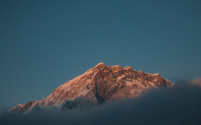 Mount Everest peak illuminated by sunset glow