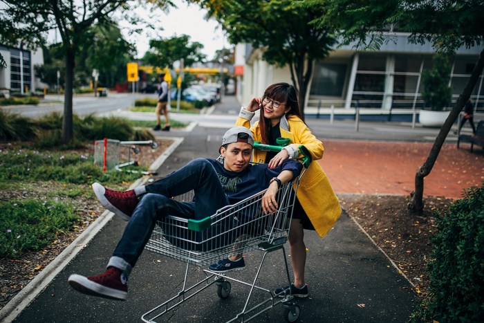 Asian couple posing in a shopping cart