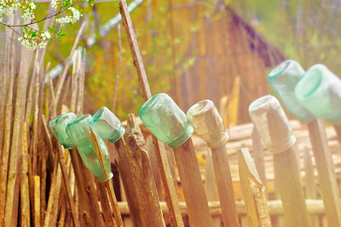 Glass jars on a wooden fence in Suceava, Romania