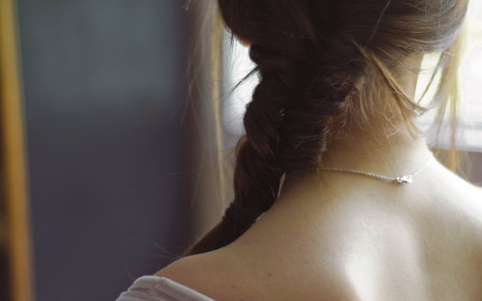 Girl with braided hair wearing a necklace