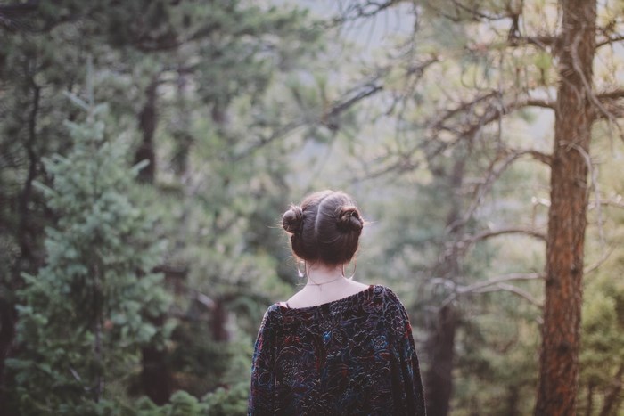 Woman with buns in a forest