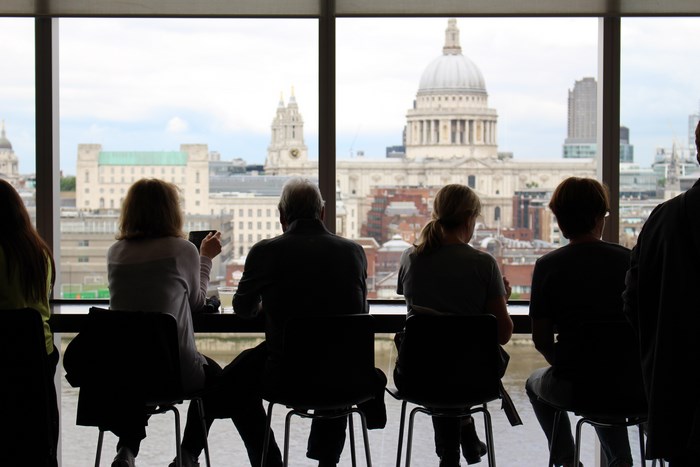 People sitting at a cafe overlooking London cityscape