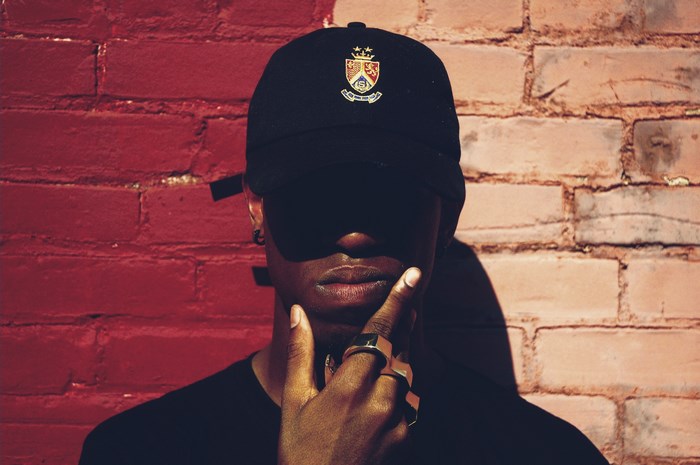 Man wearing a baseball cap with a logo
