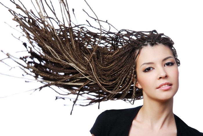 Woman with long braided hair blowing in the wind