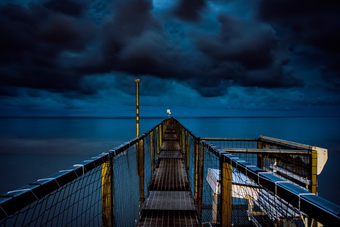 Stormy evening over a pier on a lake