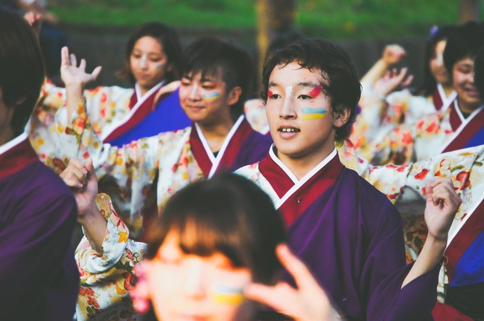 Group of teenagers performing Yosakoi dance with face paint
