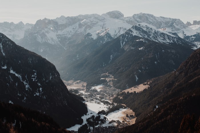Snow-capped mountains over a valley village