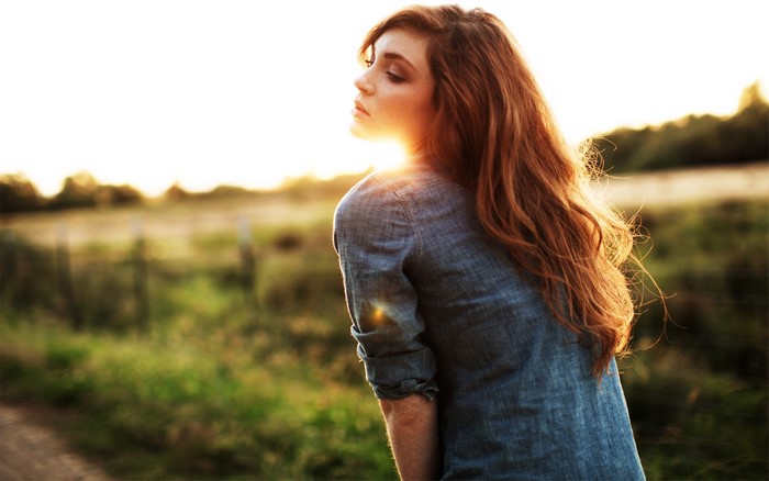 Redhead Woman Bathed in Warm Sunshine Outdoors