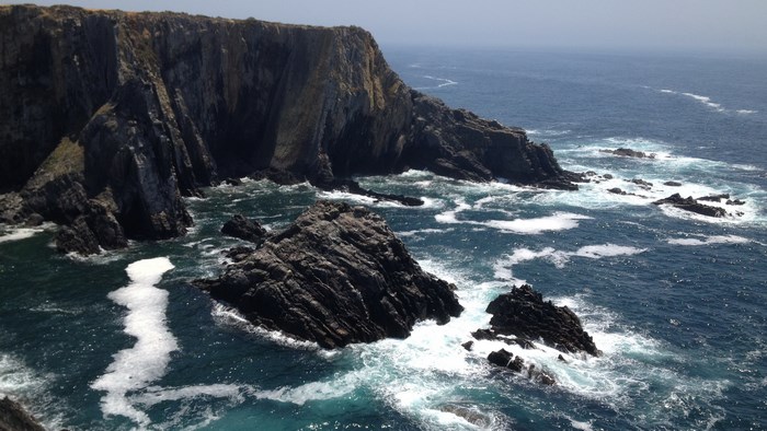 Rocky coastline with waves crashing against cliffs