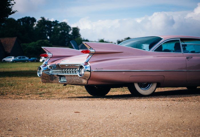 Pink Cadillac classic car with tail fins