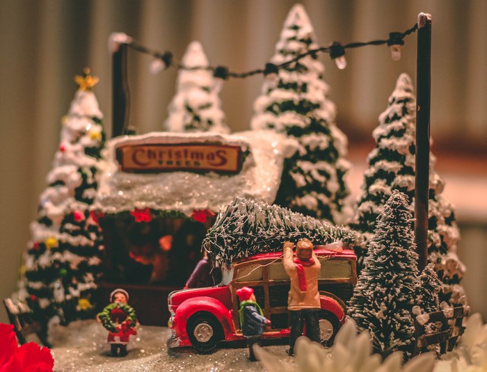 Christmas tree model with people and a red truck