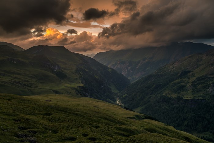 Stormy sunset over a mountain valley with a river