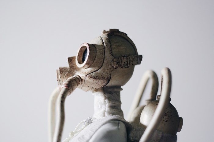 Dirty white gas mask toy with tubes