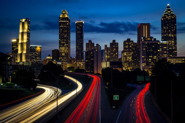 Atlanta skyline at night with light trails on freeway